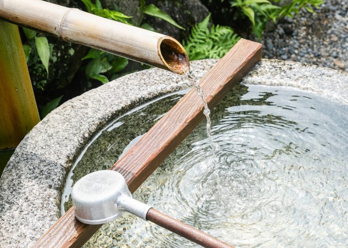 wash site besides a japanese temple for people washing hands